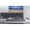 Dormitorio moderno con cuadro de paisaje olas marinas playa en el cabecero de la cama